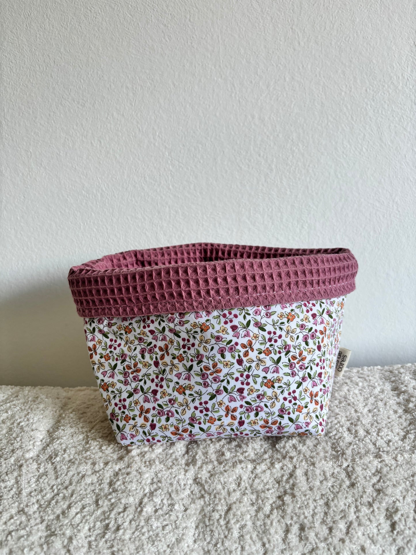 Cesta de tela artesanal con estampado floral y borde de ganchillo rosa - Fíos de Cores
